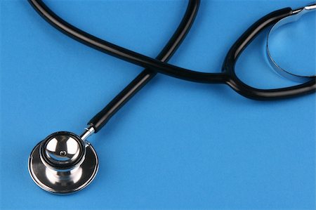 racnus (artist) - A stethoscope in plain blue background. Fotografie stock - Microstock e Abbonamento, Codice: 400-05022892