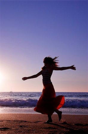 Beautiful woman dancing in the beach Stock Photo - Budget Royalty-Free & Subscription, Code: 400-05023362