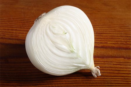 Half an onion on old wooden board Stock Photo - Budget Royalty-Free & Subscription, Code: 400-05023691