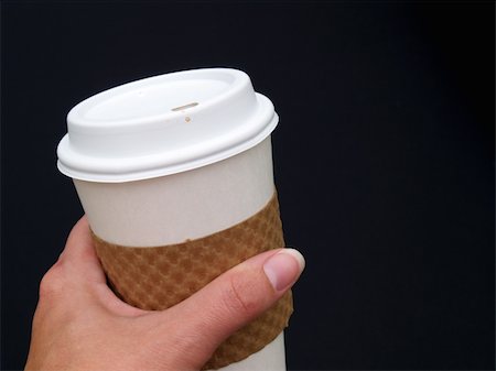 a female's hand holding a disposable paper coffee cup Stock Photo - Budget Royalty-Free & Subscription, Code: 400-05034082