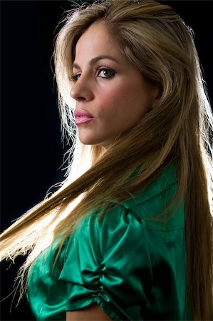 beautiful profile of blond woman face wearing green satin blouse with a serious expression Photographie de stock - Aubaine LD & Abonnement, Code: 400-05034243