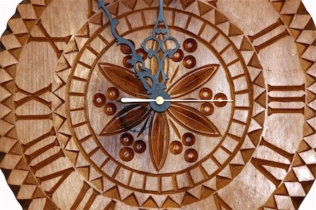 five minutes - Detailed view of a handmade clock carved on wood showing time five minutes before twelve Stock Photo - Budget Royalty-Free & Subscription, Code: 400-05034673