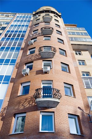 Modern building from a brick. Glass balconies. Foto de stock - Royalty-Free Super Valor e Assinatura, Número: 400-05034749