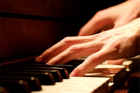 A Caucasian male's hand playing a piano in dramatic lighting Stock Photo - Budget Royalty-Free & Subscription, Code: 400-05034857