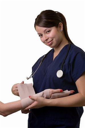 Hispanic woman healthcare worker wearing dark blue scrubs wrapping an arm with a tensor bandage wearing a stethoscope on white Stockbilder - Microstock & Abonnement, Bildnummer: 400-05034884