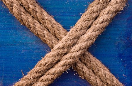 Image shows a double rope in an "X" letter formation, tied to a blue painted wooden surface Stock Photo - Budget Royalty-Free & Subscription, Code: 400-05035021