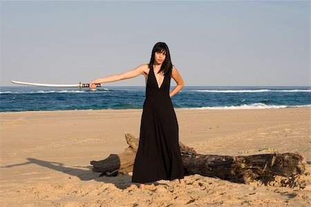 rapier - Asian model wielding a sword on the beach Photographie de stock - Aubaine LD & Abonnement, Code: 400-05035112