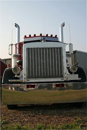 This is a picture of the front of a large semi truck, taken at a low stance with a slight angle to give the feeling of movement and power. Stock Photo - Budget Royalty-Free & Subscription, Code: 400-05035258