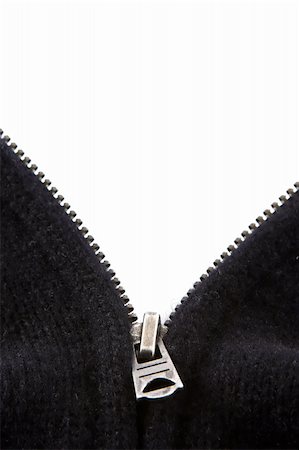 The zipper of a black sweater open in a V. The background is white for display of text. Stockbilder - Microstock & Abonnement, Bildnummer: 400-05035326