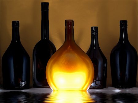 few glass bottles, one of them is lighted Stock Photo - Budget Royalty-Free & Subscription, Code: 400-05035388