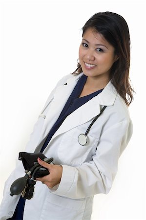 simsearch:400-03995908,k - Female attractive Asian doctor wearing white lab coat wearing a stethoscope around shoulders and holding a blood pressure cuff smiling standing on white background Stock Photo - Budget Royalty-Free & Subscription, Code: 400-05035471