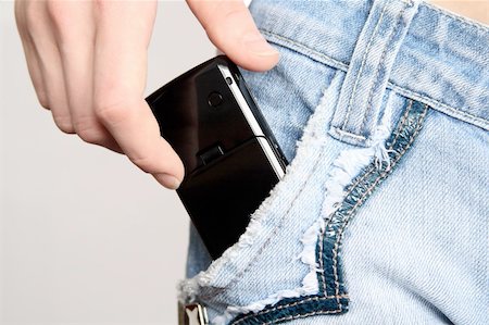 sergeitelegin (artist) - The hand gets a mobile phone from a pocket of jeans Stock Photo - Budget Royalty-Free & Subscription, Code: 400-05036633
