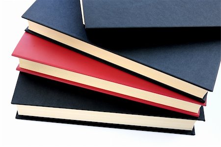 simsearch:400-05254227,k - Red and black books stacked on top of eachother isolated on white background Photographie de stock - Aubaine LD & Abonnement, Code: 400-05036681