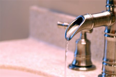 Side view up of a faucet with running water Stock Photo - Budget Royalty-Free & Subscription, Code: 400-05037075