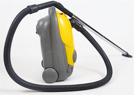 sucio - old yellow vacuum cleaner over white background Stock Photo - Budget Royalty-Free & Subscription, Code: 400-05038029