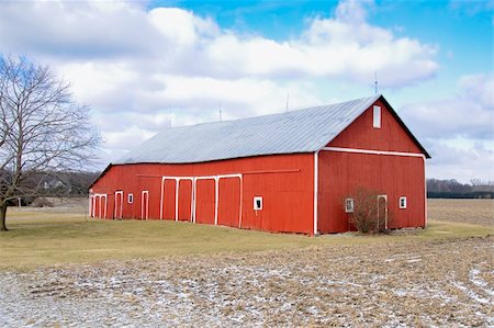 red barn in field - Bright monument agricultural survival on stark landscape in cold February Midwestern farm country. Stock Photo - Budget Royalty-Free & Subscription, Code: 400-05038134