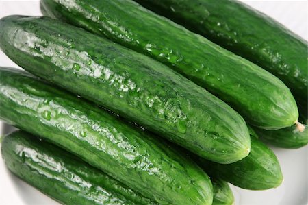 Fresh wet cucumbers on a white plate Stockbilder - Microstock & Abonnement, Bildnummer: 400-05038599