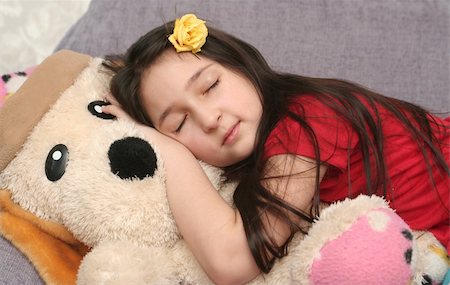 The nice girl sleeps on the big soft toy Stockbilder - Microstock & Abonnement, Bildnummer: 400-05039847