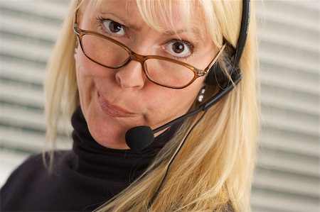 simsearch:400-04233879,k - Goofy businesswoman talks on her phone headset. Photographie de stock - Aubaine LD & Abonnement, Code: 400-05039908