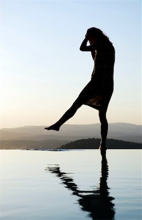 girl standing on the ledge where water ends Stock Photo - Budget Royalty-Free & Subscription, Code: 400-05039936