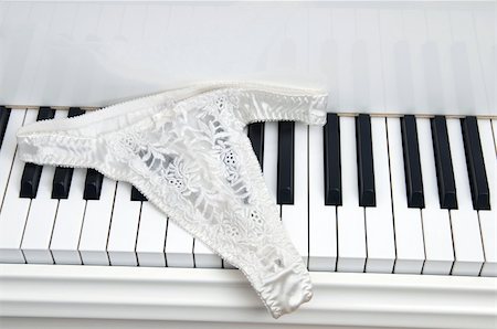 Pair of ladies lace panties on the keyboard of a white baby grand piano. Stock Photo - Budget Royalty-Free & Subscription, Code: 400-05030012