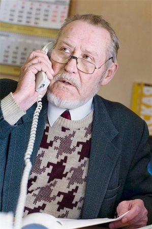 simsearch:400-04504842,k - Mature businessman talking on the phone, taking notes, checking out a document on his computer monitor. Photographie de stock - Aubaine LD & Abonnement, Code: 400-05030682