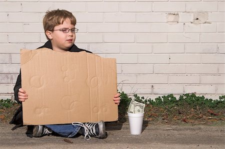 A homeless boy with a blank cardboard sign. Stock Photo - Budget Royalty-Free & Subscription, Code: 400-05030831