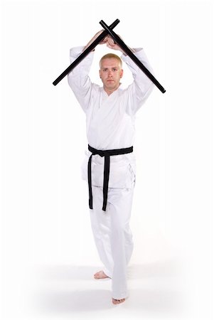 simsearch:400-04558215,k - First Degree Black Belt with tonfa. Photographie de stock - Aubaine LD & Abonnement, Code: 400-05031208