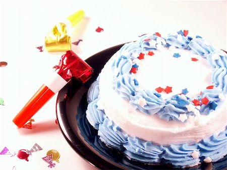 cake on plate with confetti and noisemakers on table Stock Photo - Budget Royalty-Free & Subscription, Code: 400-05031280