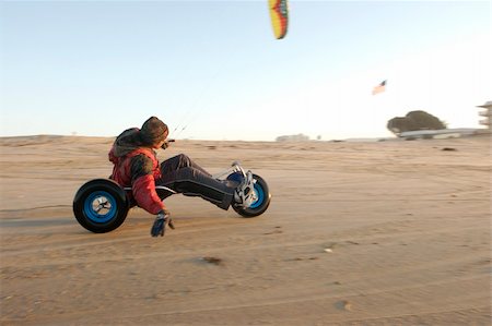 A man kite buggying at the beach at sunset Stock Photo - Budget Royalty-Free & Subscription, Code: 400-05031464