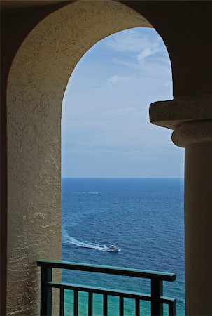 florida beach with hotel - An inviting view of a boat on the ocean through an arch of a balcony. Photographie de stock - Aubaine LD & Abonnement, Code: 400-05031628