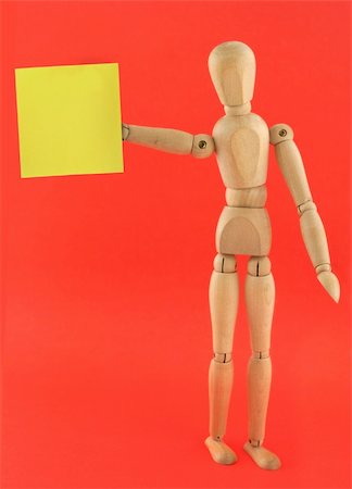 wooden figure holding empty adhesive note Fotografie stock - Microstock e Abbonamento, Codice: 400-05031635