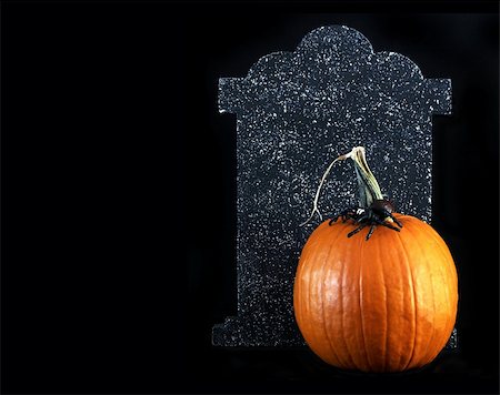 sparkia (artist) - Halloween - orange pumpkin with a spider on top and tombstone behind Stockbilder - Microstock & Abonnement, Bildnummer: 400-05031852