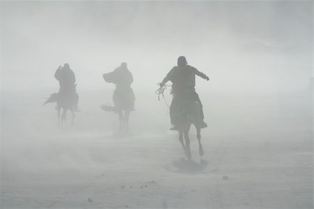 three horsemen riding in sandstorm, the sea of sands, java indonesia Stock Photo - Budget Royalty-Free & Subscription, Code: 400-05032098