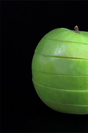 simsearch:400-05032147,k - A sliced green apple in a stack. Photographie de stock - Aubaine LD & Abonnement, Code: 400-05032145