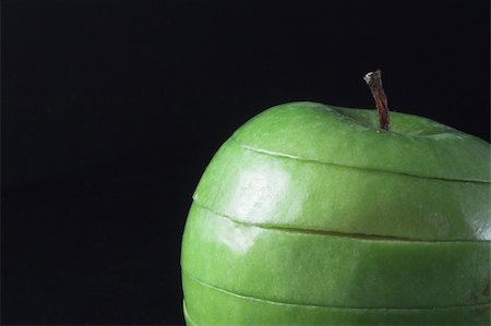 simsearch:400-05032144,k - A sliced green apple in a stack. Photographie de stock - Aubaine LD & Abonnement, Code: 400-05032147