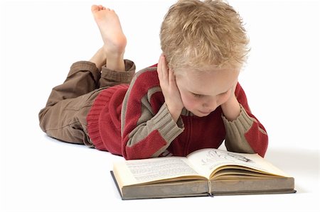 5 year old reading a book, isolated on white. Book is an old children's Bible. Fotografie stock - Microstock e Abbonamento, Codice: 400-05033187