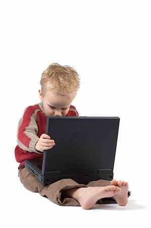 early childhood education - Five year old boy working on a laptop computer. Photographie de stock - Aubaine LD & Abonnement, Code: 400-05033188