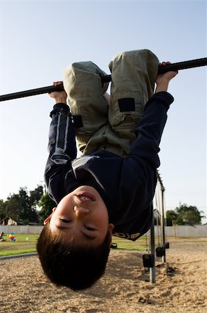 simsearch:400-03994929,k - Young asian boy hanging upside down on a playground structure Stockbilder - Microstock & Abonnement, Bildnummer: 400-05033305