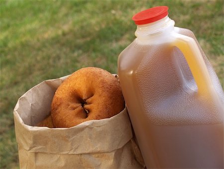 sparkia (artist) - a half-gallon of apple cider beside a bag of donuts Stockbilder - Microstock & Abonnement, Bildnummer: 400-05033339