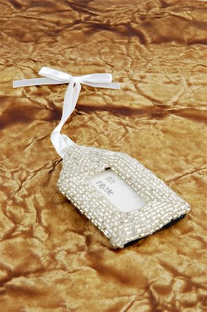 simsearch:400-04499144,k - Elegant beaded gift tag on a textured background Foto de stock - Royalty-Free Super Valor e Assinatura, Número: 400-05033376