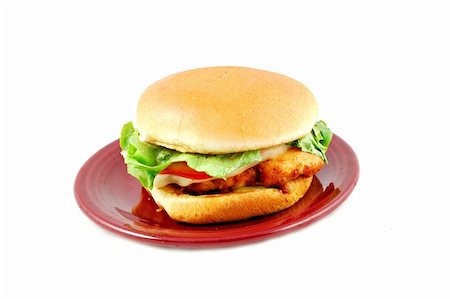 provolone - Fried chicken sandwich with lettuce, tomato, and provolone on a bun on a plate Stock Photo - Budget Royalty-Free & Subscription, Code: 400-05033380