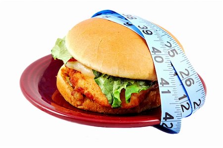 provolone - Fried chicken sandwich with lettuce, tomato, and provolone on a bun on a plate surrounded by a measuring tape. Stock Photo - Budget Royalty-Free & Subscription, Code: 400-05033381