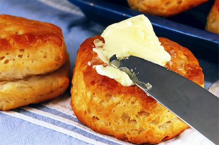 pastel dish - Buttering a homemade buttermilk biscuit in a vintage kitchen Stock Photo - Budget Royalty-Free & Subscription, Code: 400-05033399