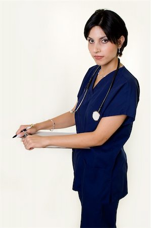 simsearch:400-03995908,k - Pretty short hair brunette woman healthcare worker wearing blue scrubs and a stethoscope holding a clipboard Stock Photo - Budget Royalty-Free & Subscription, Code: 400-05033513