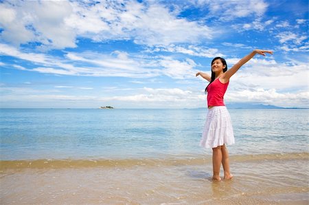 eyedear (artist) - girl with a red tank top and white skirt stretching on a beautiful day at the beach Stock Photo - Budget Royalty-Free & Subscription, Code: 400-05044009