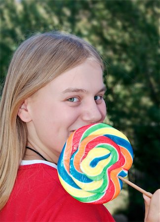 a girl with a brig swirly lollipop Stock Photo - Budget Royalty-Free & Subscription, Code: 400-05044049