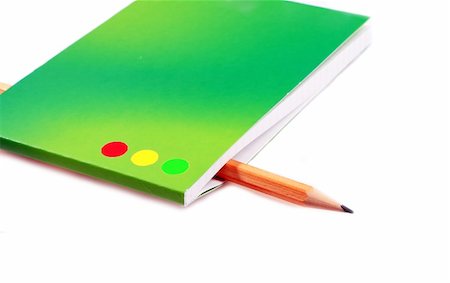 sergeitelegin (artist) - The pencil is inserted into a green notebook Stock Photo - Budget Royalty-Free & Subscription, Code: 400-05045384
