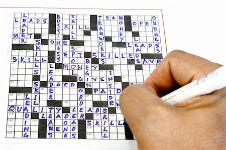 simsearch:600-02659564,k - working on a crossword puzzle with highlights on skills and teamworks Fotografie stock - Microstock e Abbonamento, Codice: 400-05045881