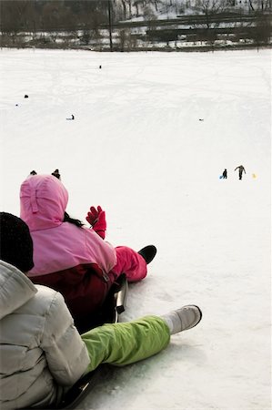 person riding toboggan - kids tobogganing on a warm winter day Stock Photo - Budget Royalty-Free & Subscription, Code: 400-05046537